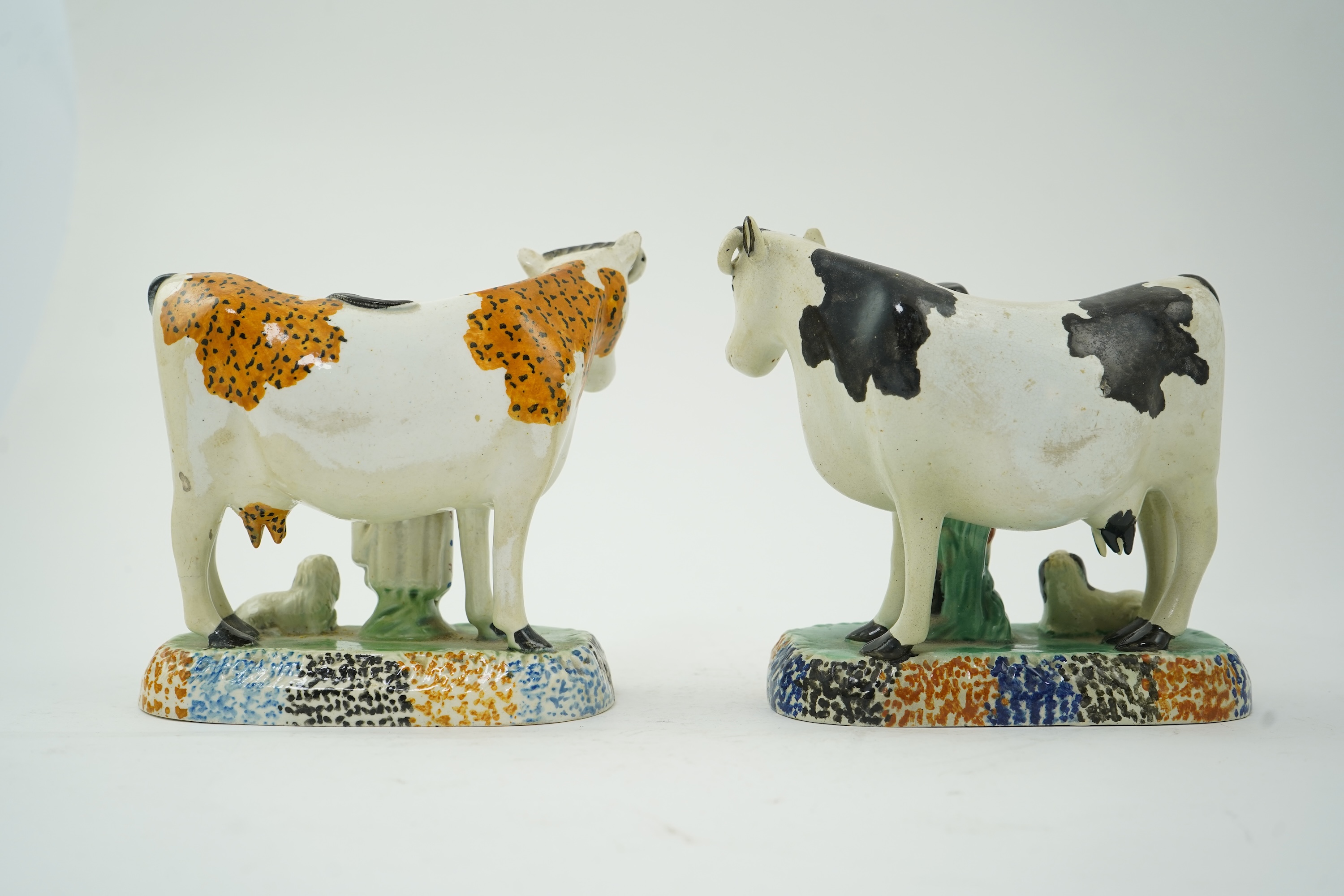 Two Yorkshire Prattware cows, with farmer or milkmaid and dog groups, c.1810